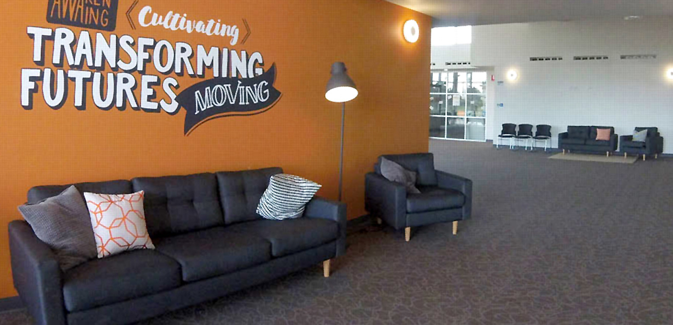 Large comfy couches with cozy cushions line the walls of the church foyer.